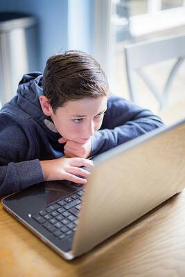 Wall Art - Photograph - Boy Using A Laptop #1 by Science Photo Library