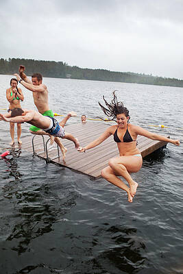 Wall Art - Photograph - Group Of Twenty Year Olds Jump #1 by Monica Donovan
