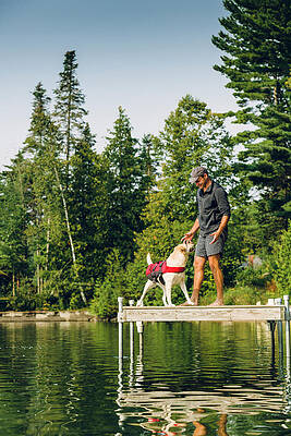Wall Art - Photograph - Man And Dog Sitting On The Dock #1 by Corey Hendrickson