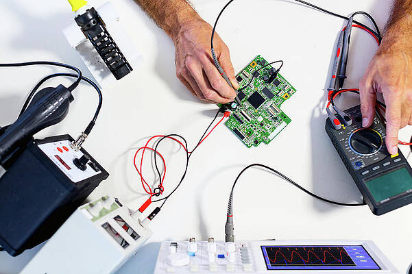 Wall Art - Photograph - Person Working In An Electronics Lab #1 by Science Photo Library