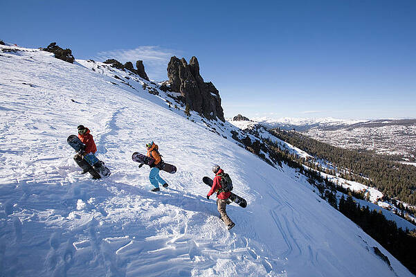 Wall Art - Photograph - Three Snowboarders Hike To The Top #1 by Jose Azel