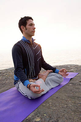Wall Art - Photograph - A  Man Practicing Yoga On A Rocky #2 by Lars Schneider