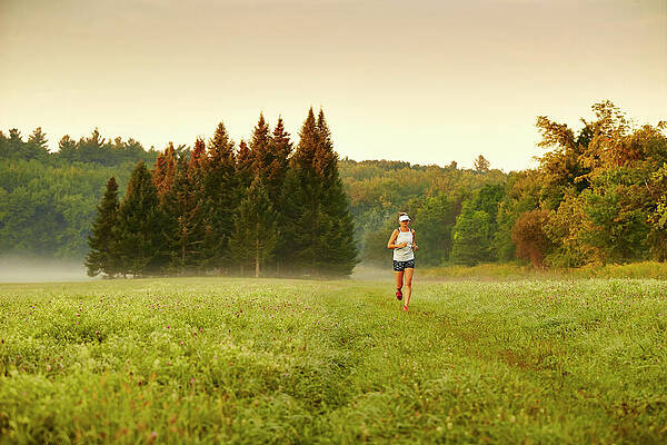 Wall Art - Photograph - A Woman Running Through A Field #2 by Josh Campbell
