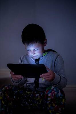 Wall Art - Photograph - Boy Using A Digital Tablet In The Dark #2 by Science Photo Library