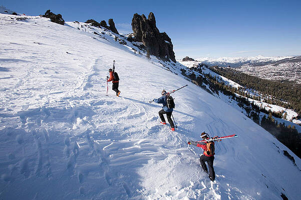 Wall Art - Photograph - Three Skiers Hike To The Top Of A Hill #2 by Jose Azel