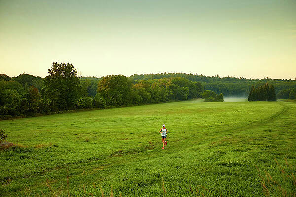 Wall Art - Photograph - A Woman Running Through A Field #3 by Josh Campbell