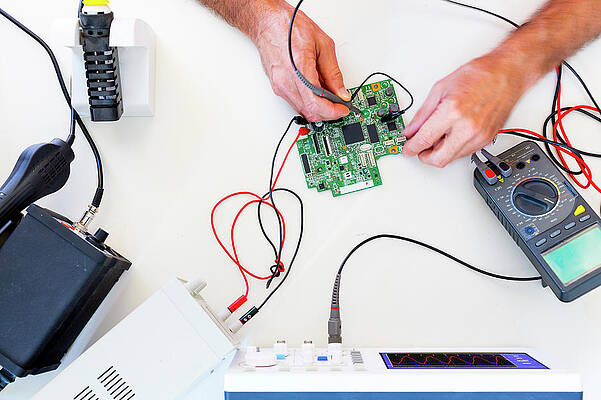 Wall Art - Photograph - Person Working In An Electronics Lab #3 by Science Photo Library