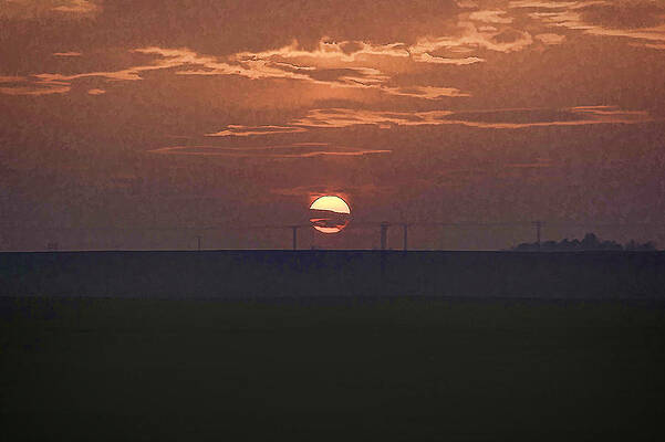 The setting sun in the distance with clouds by Ashish Agarwal The setting sun in the distance with clouds by Ashish Agarwal