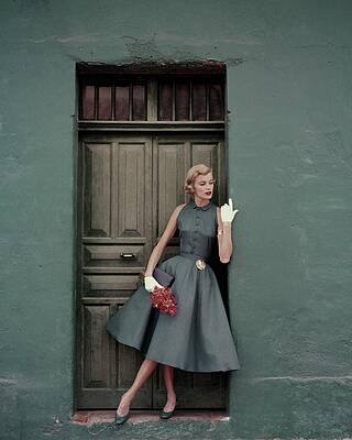 Wall Art - Photograph - A 1950s Model Standing In A Doorway by Leombruno-Bodi