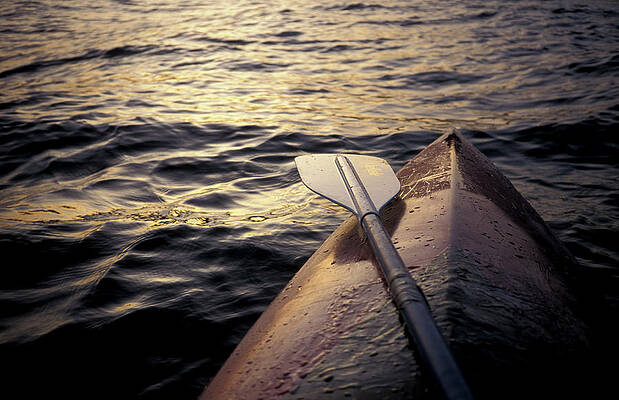 Wall Art - Photograph - A Kayak Floats In The Water by Chris Pinchbeck