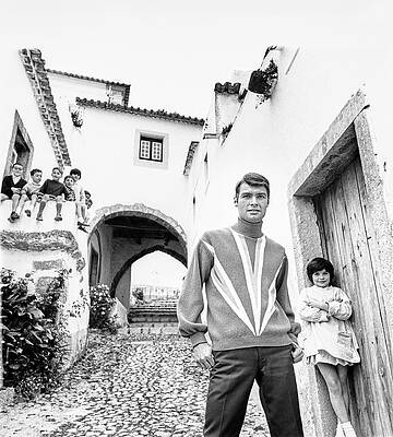 Wall Art - Photograph - A Male Model Posing While A Group Of Children by Leonard Nones