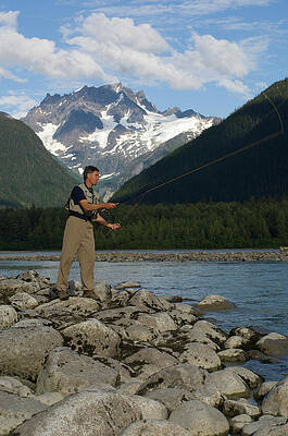 Wall Art - Photograph - A Man Fly Fishes A Stream In British by Doug Marshall
