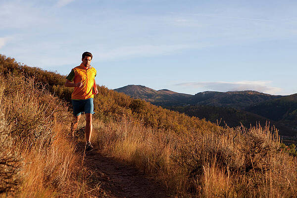 Wall Art - Photograph - A Man Out For An Early Evening Run by Mike Schirf