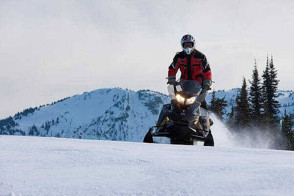 Wall Art - Photograph - A Man Rides A Snowmobile In A Standing by Craig Pulsifer