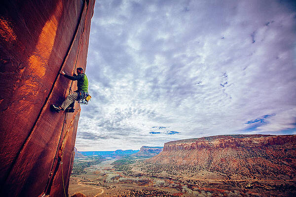 Wall Art - Photograph - A Man Rock Climing In Indain Creek, Utah by Mike Schirf