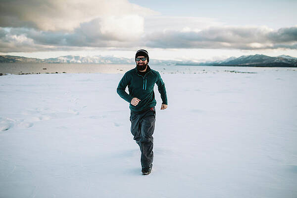 Wall Art - Photograph - A Man Running In The Snow by Ryan Tuttle