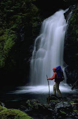 Wall Art - Photograph - A Man Standing In Front Of Waterfall by Lars Schneider