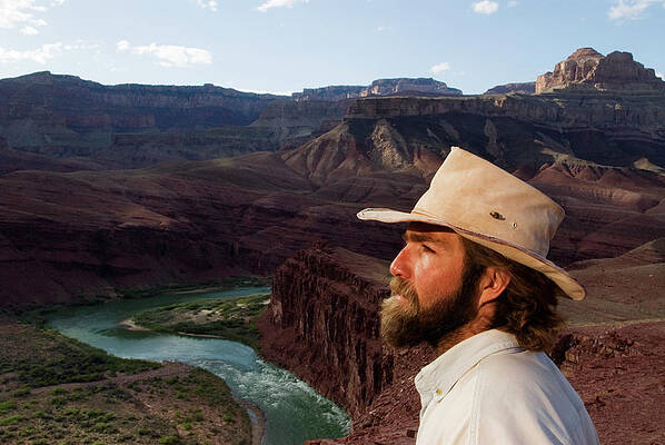 Wall Art - Photograph - A Middle-age Man In A Cowboy Hat Looks by Kyle George