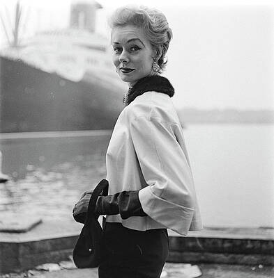 Wall Art - Photograph - A Model Standing On A Dock In A Kidskin Jacket by Richard Rutledge