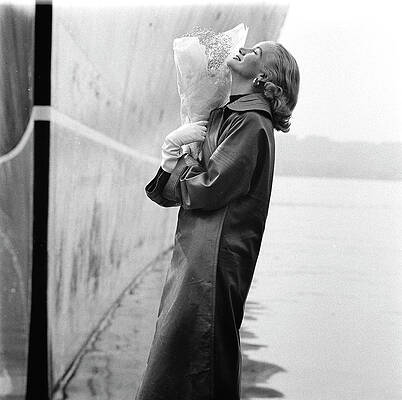 Wall Art - Photograph - A Model Standing On A Dock In A Leather Coat by Richard Rutledge