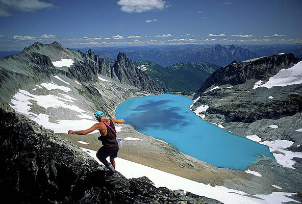 Wall Art - Photograph - A Mountain Scrambler Balances On A High by Cliff Leight