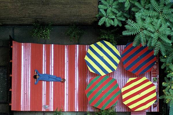 Wall Art - Photograph - A Patio With Striped Umbrellas by James Mathews