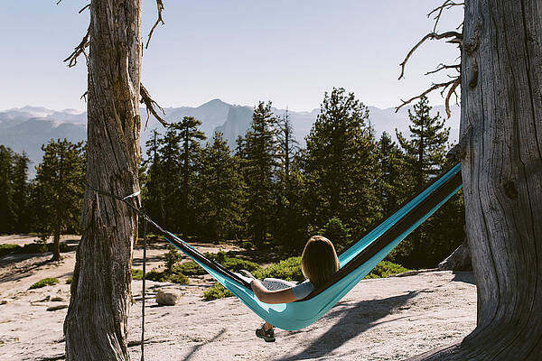 Wall Art - Photograph - A Woman Relaxing In A Hammock by Ryan Tuttle