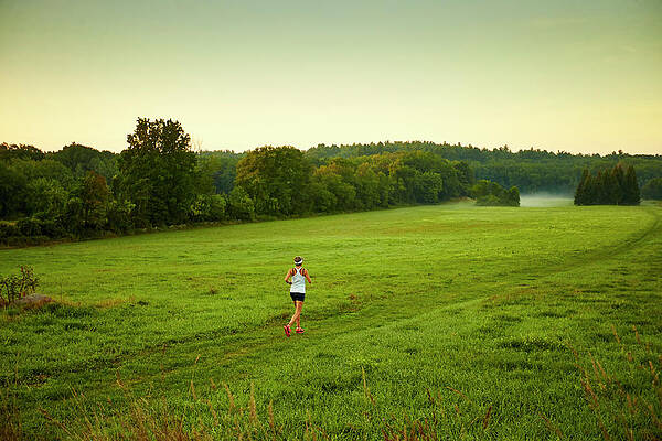Wall Art - Photograph - A Woman Running Through A Field by Josh Campbell