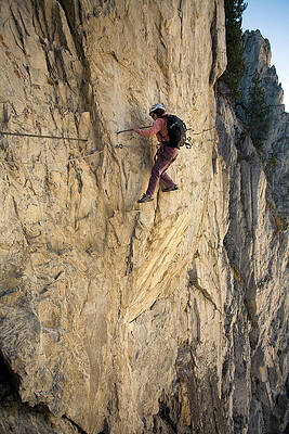 Wall Art - Photograph - A Young Woman Traverses A Cliff While by Olivier Renck