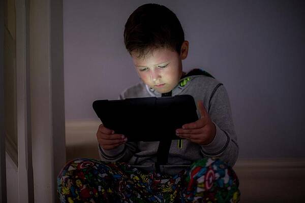 Wall Art - Photograph - Boy Using A Digital Tablet In The Dark by Science Photo Library