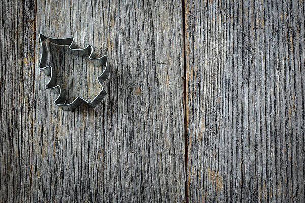 Wall Art - Photograph - Christmas Tree Cookie Cutter on Rustic Wood Background by Brandon Bourdages