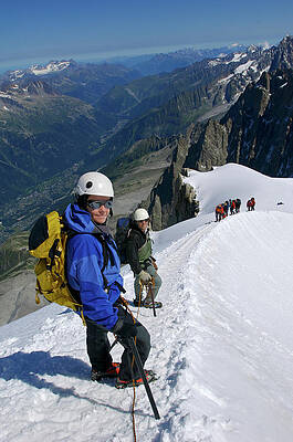 Wall Art - Photograph - Climbers Make Their Way Along A Ridge by Marc Pagani