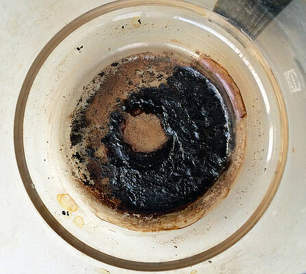 Wall Art - Photograph - Coffeepot with black burnt in coffee by Matthias Hauser