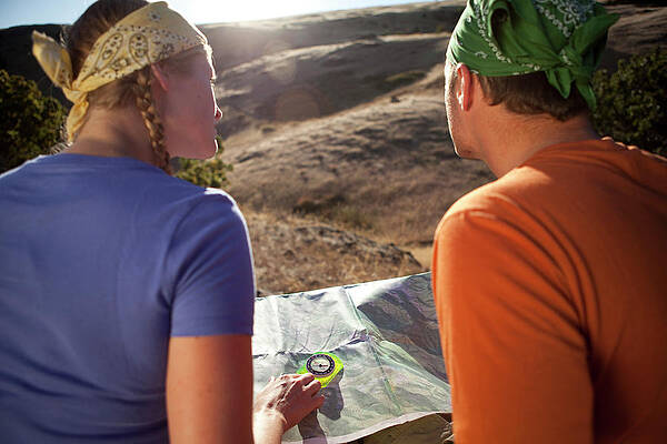 Wall Art - Photograph - Couple Using A Map While by Jordan Siemens