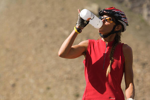 Wall Art - Photograph - Cyclists Rehydrates After Long Ride by Heath Korvola