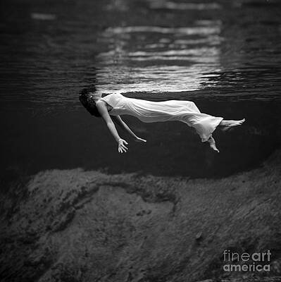 Wall Art - Photograph - Fashion Model Floating In Water, 1947 by Science Source