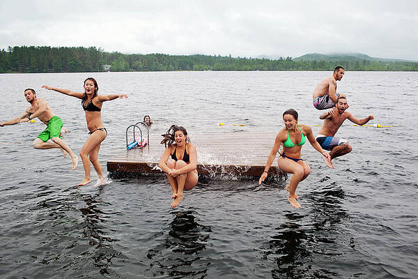 Wall Art - Photograph - Group Of Twenty Year Olds Jump by Monica Donovan