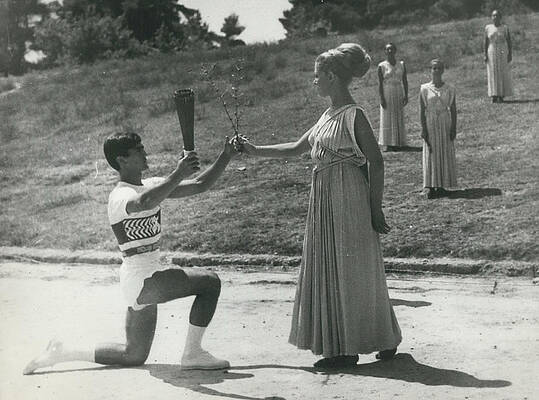 Wall Art - Photograph - Lighting the Olympic torch at ancient Olympic by Retro Images Archive