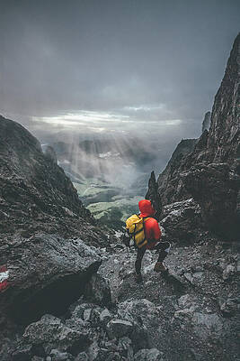 male mountaineer standing in harsh rockformation with a panorama by Leander Nardin male mountaineer standing in harsh rockformation with a panorama by Leander Nardin