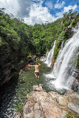 Wall Art - Photograph - Man Cliff Jumping From Waterfall by Vitor Marigo