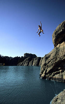 Wall Art - Photograph - Man Cliff Jumping Into Lake by Tyler Stableford