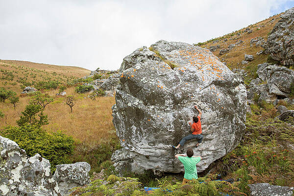 Wall Art - Photograph - Man Climbing On Boulder While Another by Alexandra Simone