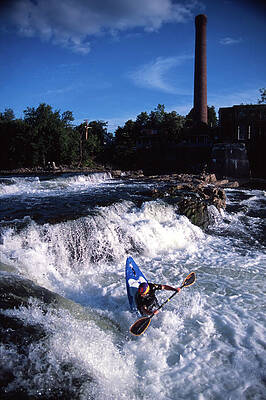 Wall Art - Photograph - Man Kayaking In River Next To Old Mill by Corey Hendrickson