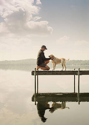 Wall Art - Photograph - Man Petting Dog On The Dock Of A Lake by Corey Hendrickson