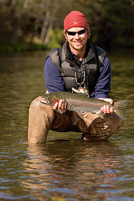 Wall Art - Photograph - Man Releasing A Steelhead by Justin Bailie