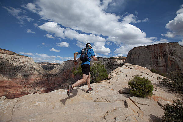 Wall Art - Photograph - Man Trail Running In Zion by Jordan Siemens