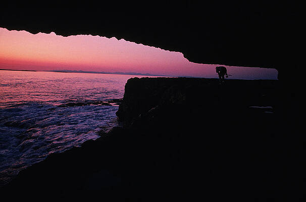 Wall Art - Photograph - Man Walking Under Cliff With Fishing by Susie Post Rust