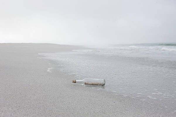 Wall Art - Photograph - Message In Bottle Washed Up On Beach by Zero Creatives