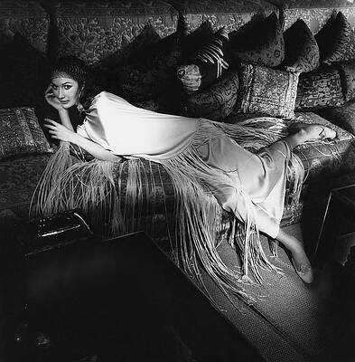 Wall Art - Photograph - Model Lying On A Couch In A Antonelli Poncho by Henry Clarke