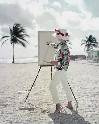 Wall Art - Photograph - Model Standing On A Beach In Front Of An Easel by Frances McLaughlin-Gill